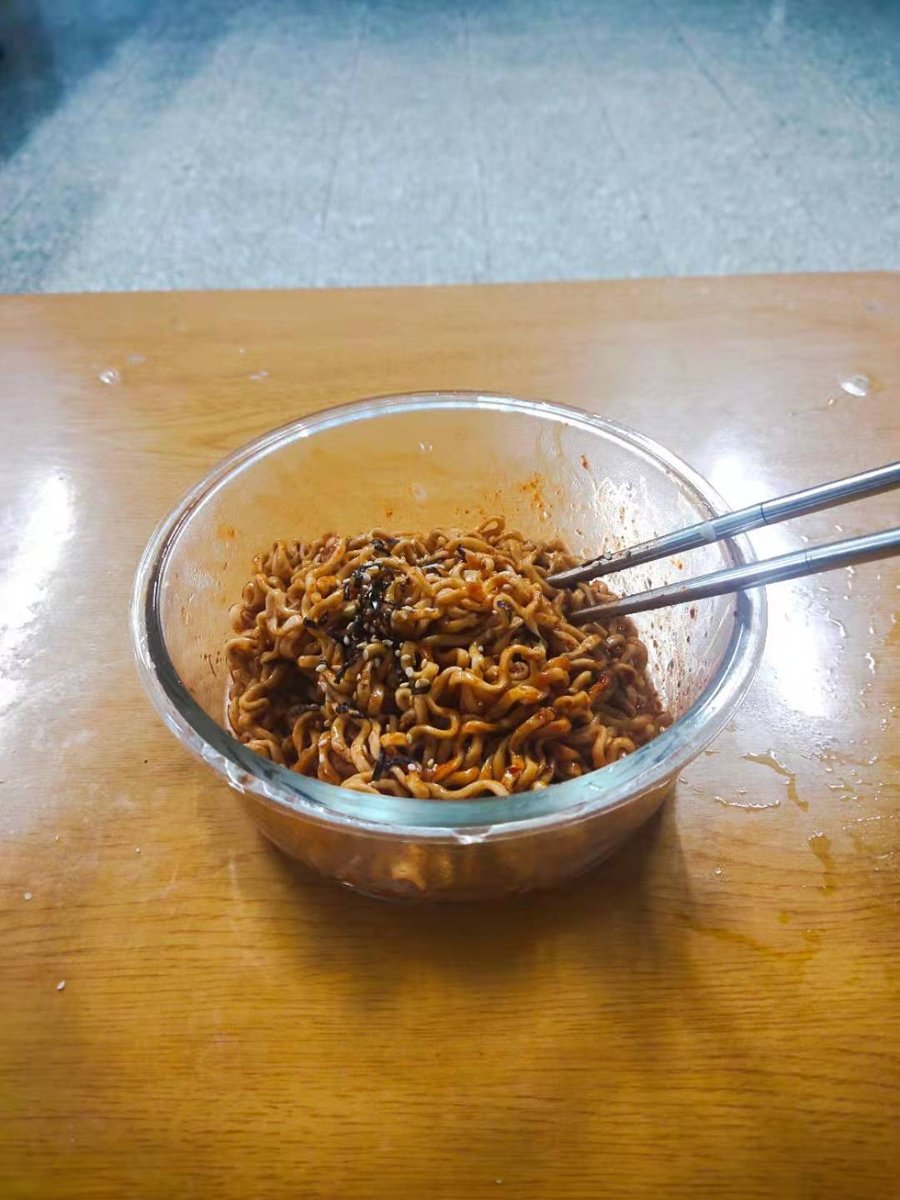 Cooked Buldak fire noodles — the signature red-orange color