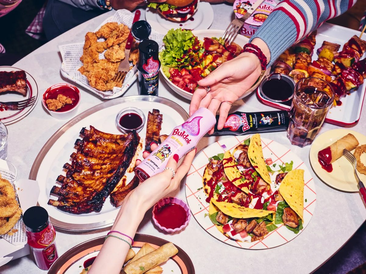 Buldak sauce and dishes on a table — Samyang's Buldak universe